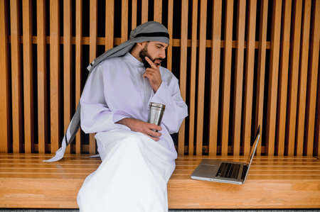Young arabian businessman working on a laptop and looking involvedの写真素材
