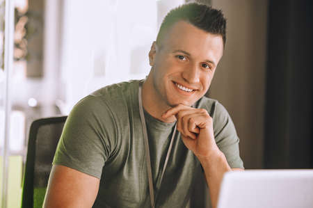Handsome young man working at the laptop