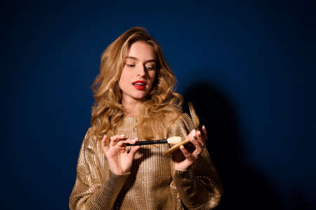 Girl looking at brush and powder in her hands