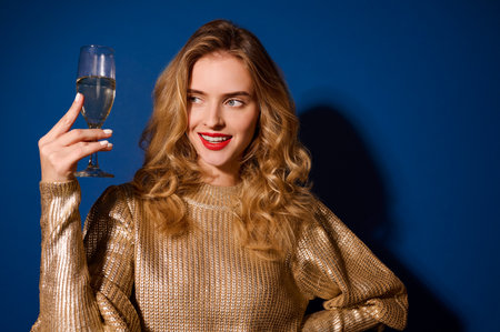 Girl looking at glass of champagne holding at face levelの写真素材