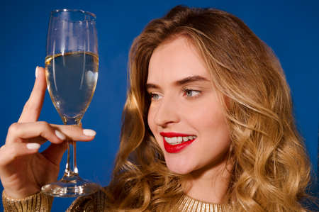 Face of girl looking at glass of champagne