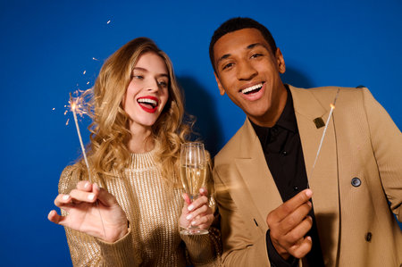 Guy and girl with champagne and sparklersの写真素材