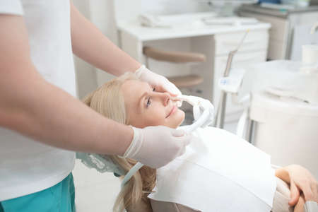 A dentist getting his patient ready to the dental surgeryの写真素材