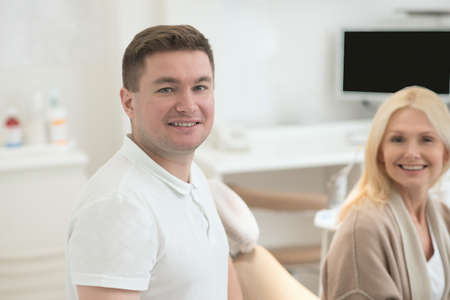 Happy doctor and his patient after the dental surgeryの写真素材