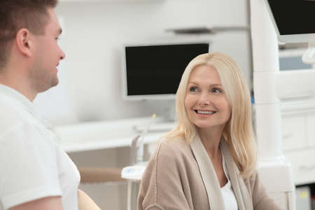 Happy doctor and his patient after the dental surgeryの写真素材