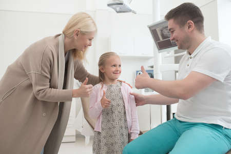 A blonde woman and her kid having appointment at the dentistsの写真素材