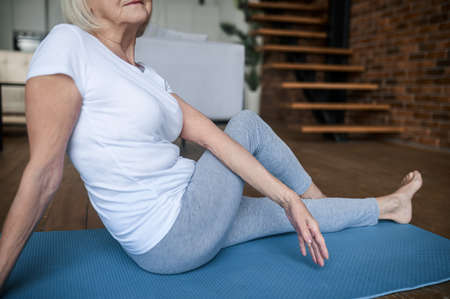 Woman in white tshirt and leggins doing stretchingの写真素材