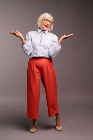 Stylish senior woman in white blouse looking confidentの写真素材