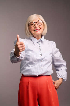 Good-looking senior woman in eyeglasses feeling good and confidentの写真素材