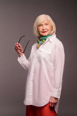 Blonde woman in stylish clothes looking good and confidentの写真素材