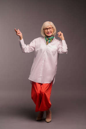 Blonde woman in stylish clothes looking good and enjoyedの写真素材