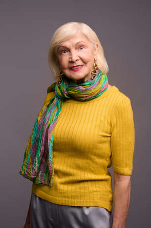 Cute woman in yellow shirt and with a green scarfの写真素材