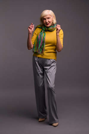 Cute woman in yellow shirt and with a green scarfの写真素材