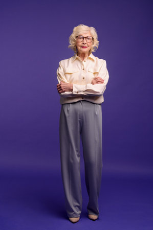 Slim and pretty blonde senior woman in stylish clothesの写真素材