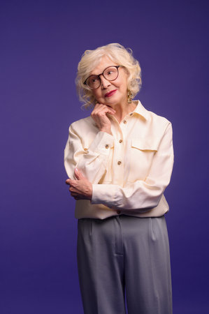 Slim and pretty blonde senior woman in stylish clothesの写真素材