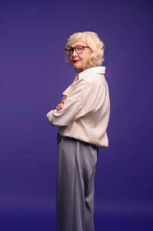 Slim and pretty blonde senior woman in stylish clothesの写真素材