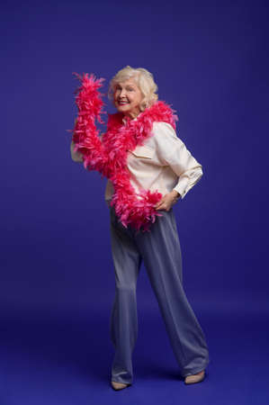 Energetic elegant woman with a feather boa on her shoulderの写真素材