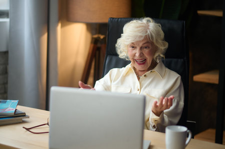 Woman looking at laptop gesturing with handsの写真素材