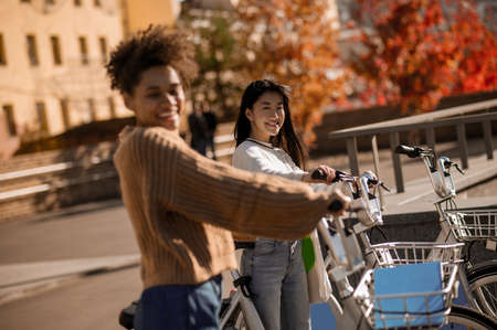 Two girls with bicycles looking at cameraの写真素材