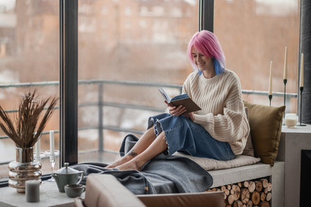 Girl with dyed hair spending a day at homeの写真素材