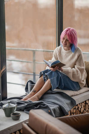 Girl with dyed hair spending a day at homeの写真素材