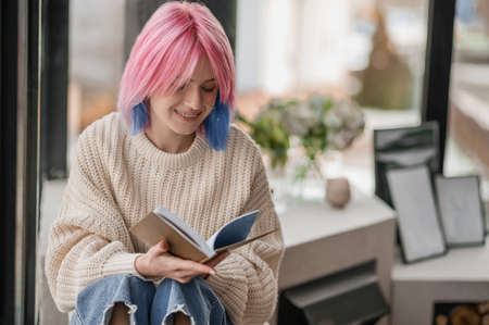 Girl with dyed hair spending a day at homeの写真素材