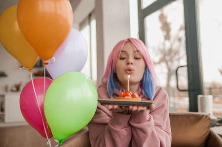 A cute girl with balloons spendng a ay in a fancy moodの写真素材