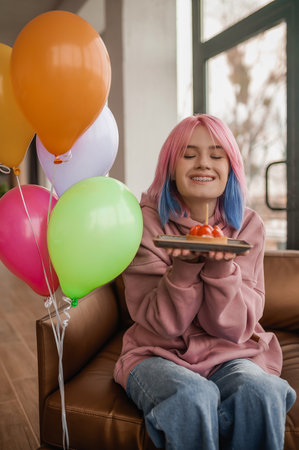 A cute girl with balloons spendng a ay in a fancy moodの写真素材