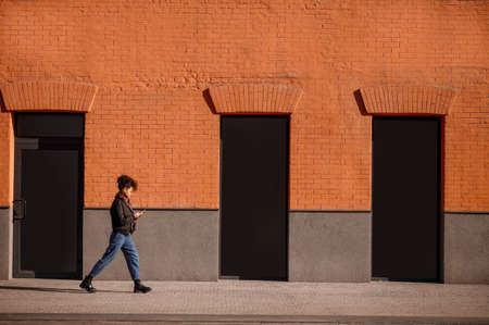 A female figure of a background of brick wallの写真素材