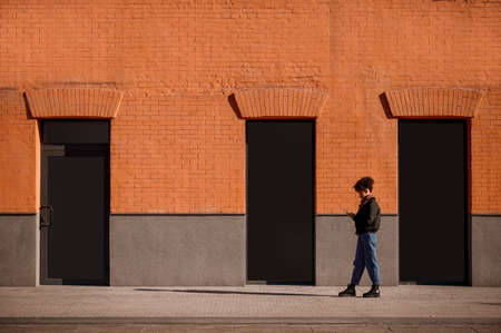 A female figure of a background of brick wallの写真素材
