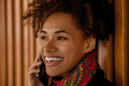 A pretty dark-skinned girl with a phoneの写真素材