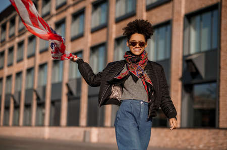 A dark-skinned girl with american flag in handsの写真素材