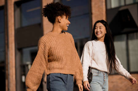 Two cute girls walking together in the streetの写真素材