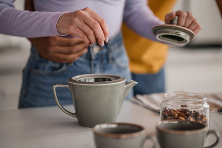 A couple making tea in the kitchenの写真素材