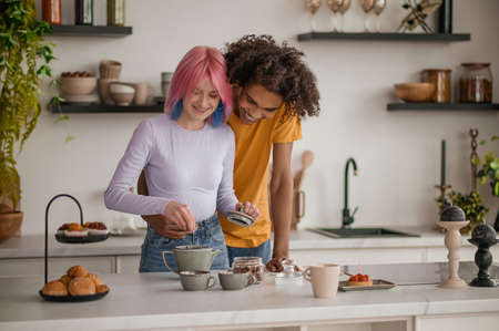 A couple making tea in the kitchenの写真素材