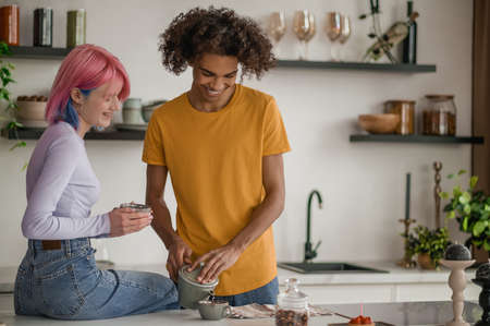 Happy young couple in the kitchenの写真素材
