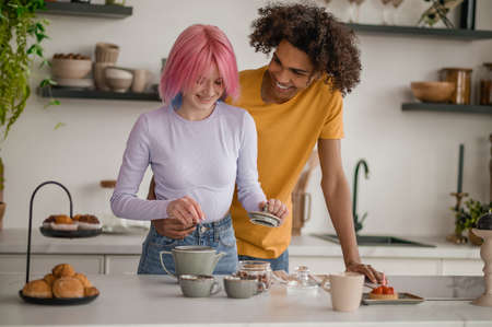 A couple making tea in the kitchenの写真素材