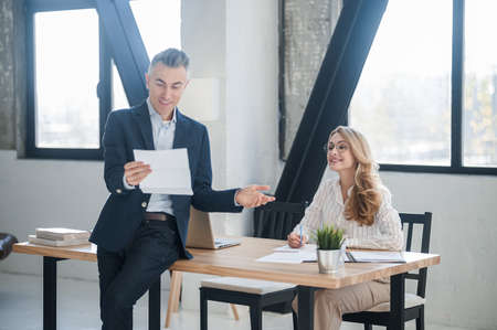 A man in a suit with documents in handsの写真素材