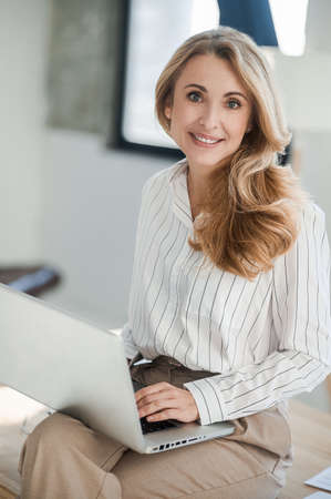 A bnlonde pretty woman working in the officeの写真素材