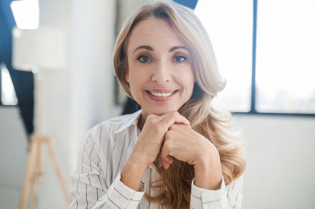 A blonde beautiful woman smiling and looking positiveの写真素材