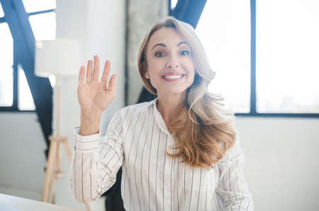A blonde beautiful woman smiling and looking positiveの写真素材