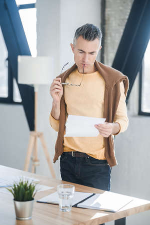 A man in casual clothes working in the officeの写真素材