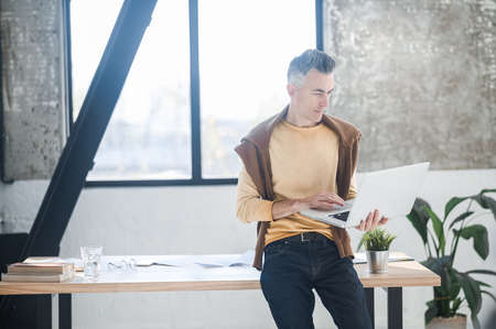 A man in casual clothes working in the officeの写真素材