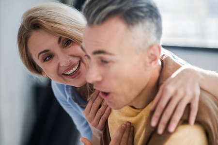 A couple in the office looking interetsed while reading newsの写真素材