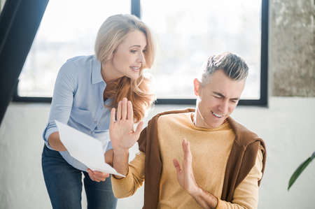 A man and a woman in the office talking and discussing a projectの写真素材