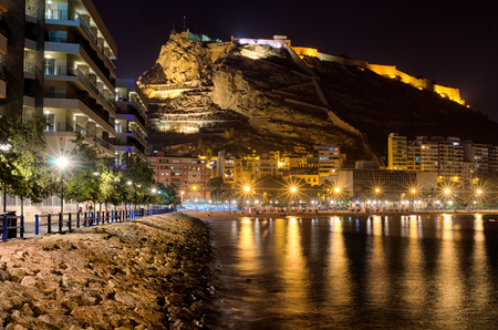 Cosy evening harbor in Alicante surrounded by houses and mountains, summer in Spainの写真素材