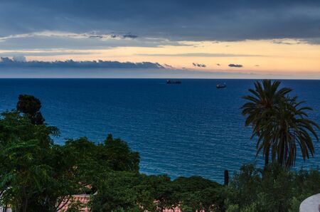 Orange dramatic sunset view on mediterranean sea near Tarragona, summer Spainの写真素材
