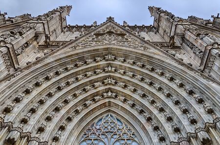 Lacy decoration of cathedral entrance in details in Barcelona, summer Spainの写真素材