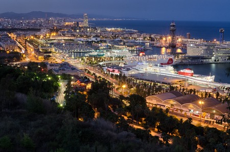Detailed panoramic view on night illumination of Barcelona port with cruising liners, summer Spainの写真素材