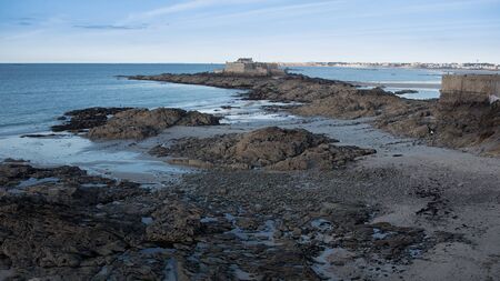 Bare rocks on sandy beach in Saint-Malo, Franceの写真素材